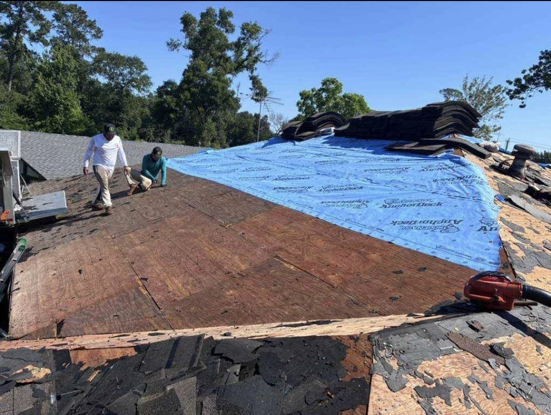 During: roofing crew replacing decking and installing underlayment on a Houston roof
